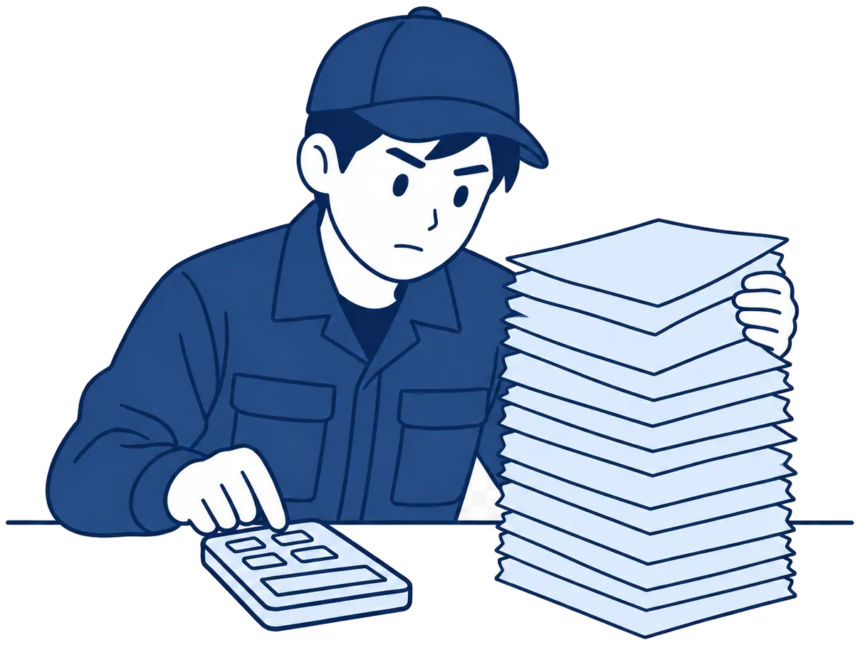 机で電卓を打ちながら、紙の山と向き合っている担当者